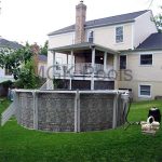 Oval Dauntless Above Ground Pool and Equipment behind house