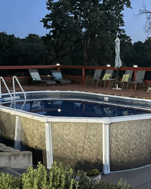 Atlas pool with white frame and wheat wall