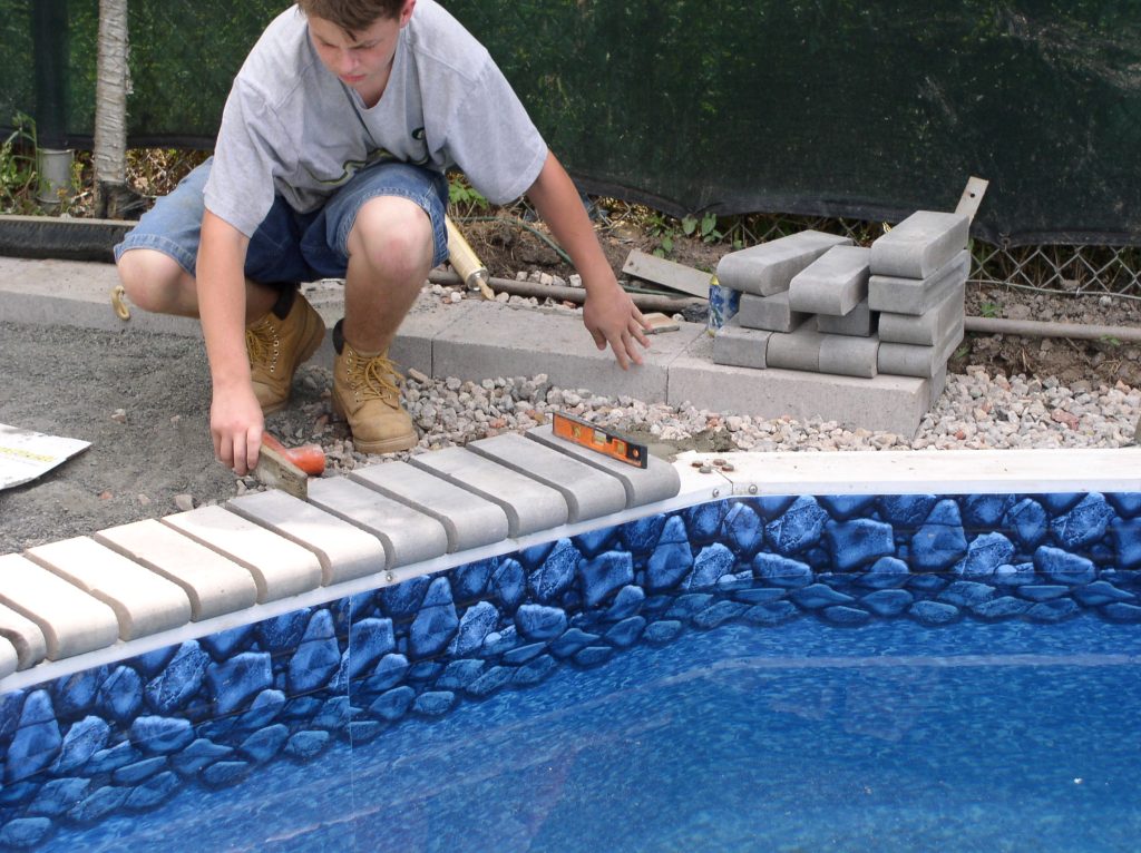 OLYMPUS DIGITAL CAMERA - MGK Pools Inc Laying patio pave coping stones on inground Aquasport 52
