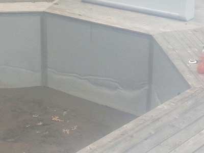 Radiant semi inground pool with damage