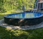 semi inground pool with stone veneer