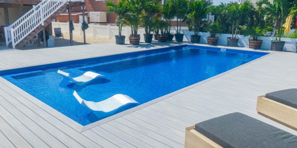 Ponce with tanning ledge chairs - MGK Pools Inc Fiberglass pool with tanning ledge and lounge chairs