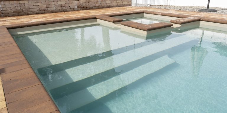 Beautiful fiberglass pool with spa and tanning ledge