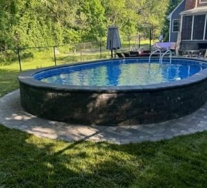 semi inground pool with stone veneer